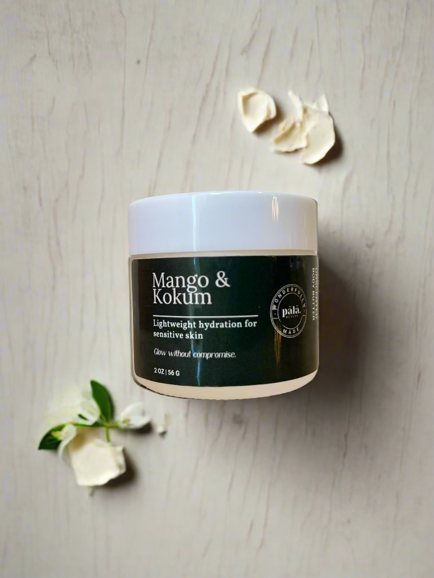 Jar of Mango & Kokum skincare product on a wooden surface with a white background